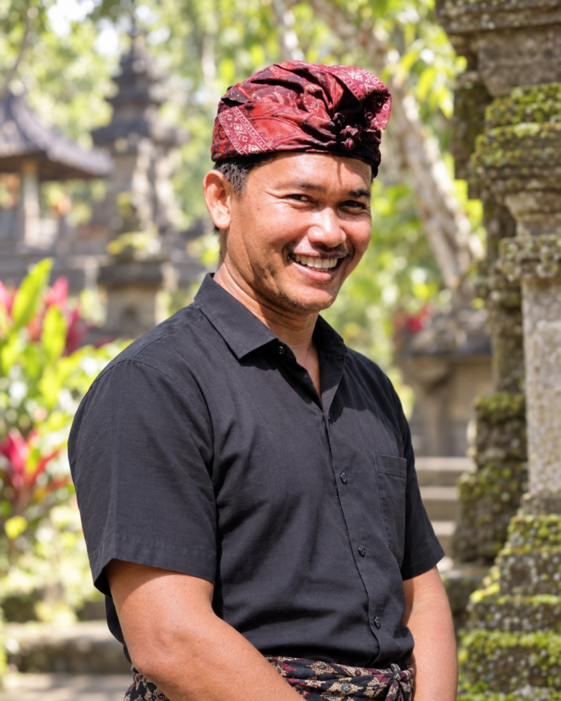 Wandi, Emre Konuralp’s trusted local guide and driver in Bali, smiling in traditional Balinese udeng at a temple