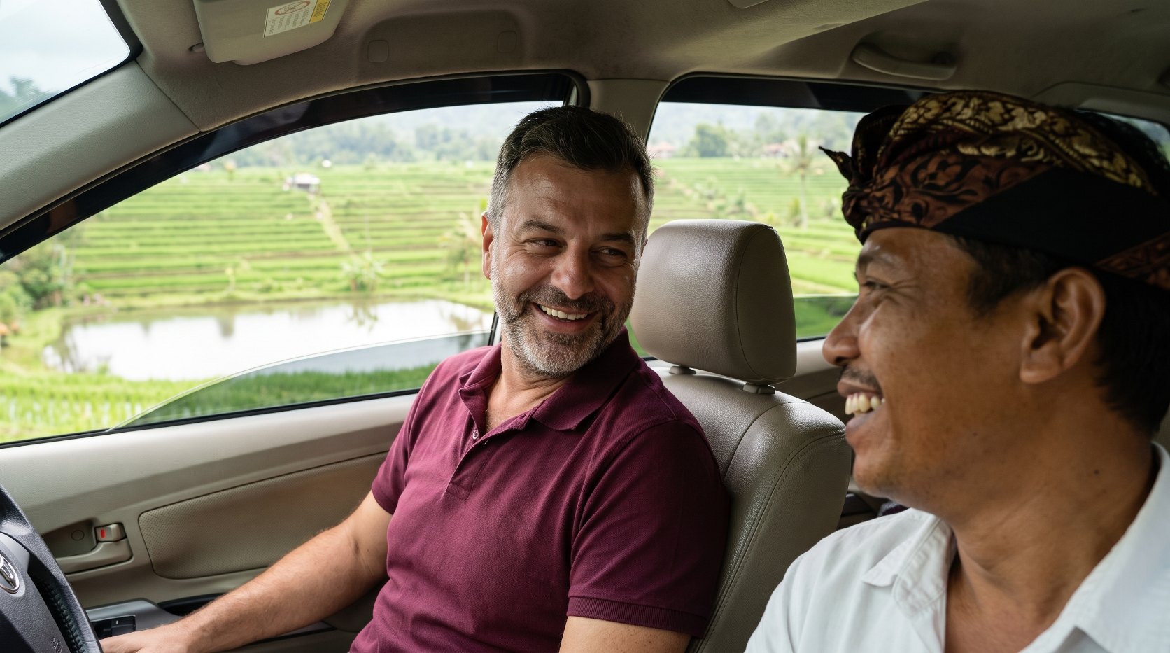 Emre Konuralp with a Balinese private driver on a highland road — AI editorial illustration